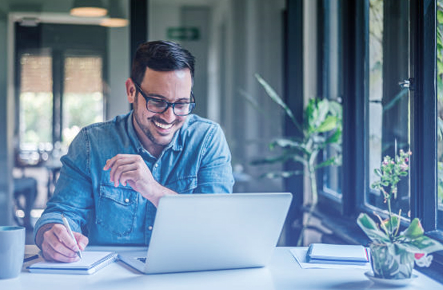 Compliance - man working happy on computer